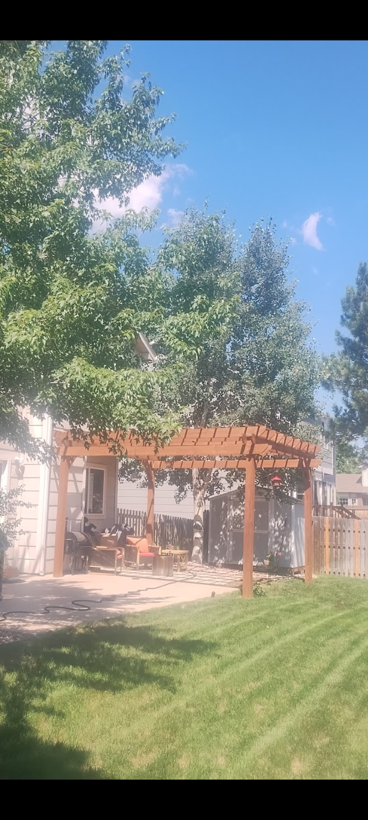 Cedar pergola over a concrete back patio