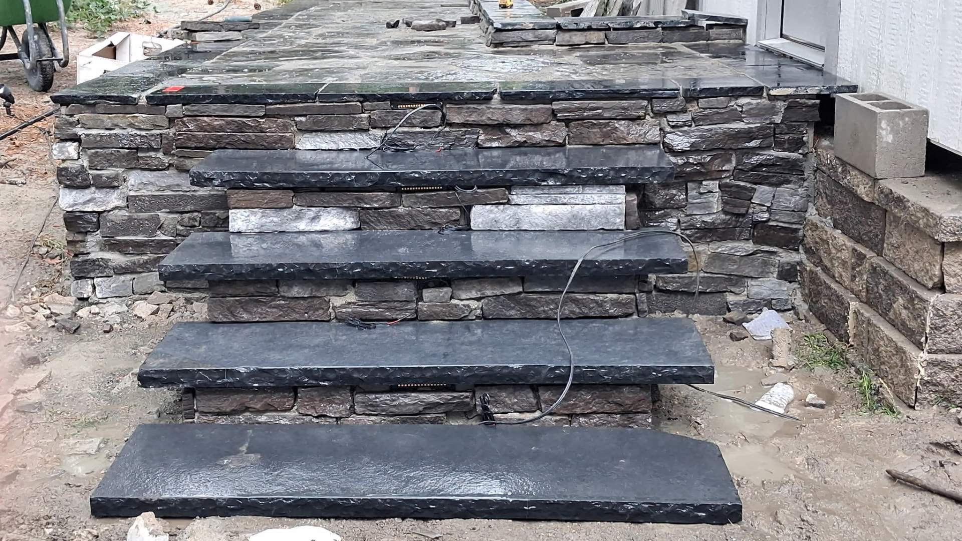 Natural flagstone steps set into a stone wall