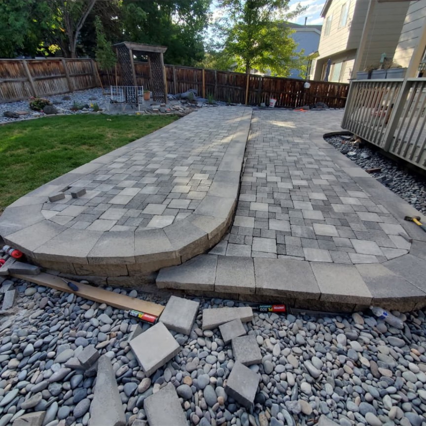 Two-tone curved paver patio with raised border